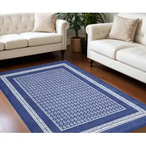 Photo of Blue And Ivory Geometric Distressed Area Rug