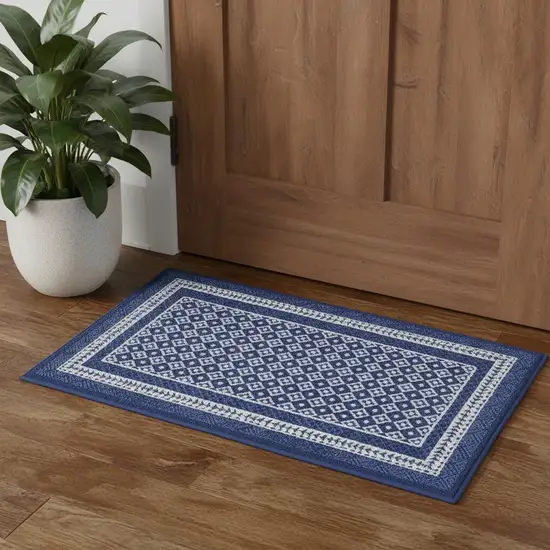 Blue And Ivory Geometric Distressed Area Rug Photo 1