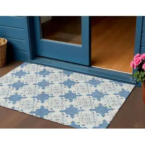 Photo of Blue And Ivory Quatrefoil Washable Indoor Outdoor Area Rug