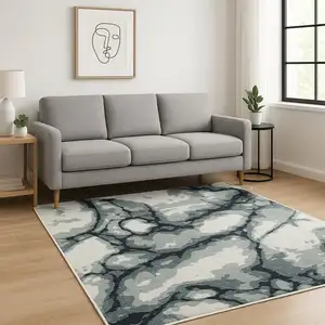 Photo of Blue Black And Ivory Abstract Area Rug With Fringe