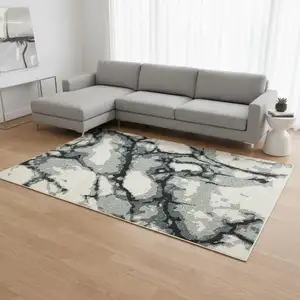 Photo of Blue Black And Ivory Abstract Area Rug With Fringe