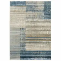 Photo of Blue Dark Blue Teal Grey Ivory Beige And Tan Geometric Power Loom Stain Resistant Area Rug With Fringe