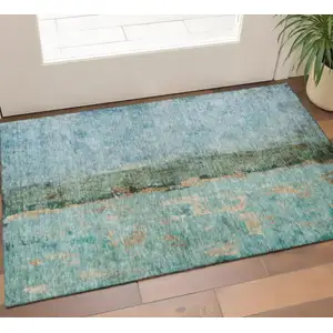 Photo of Blue Gold And Green Abstract Washable Area Rug With UV Protection