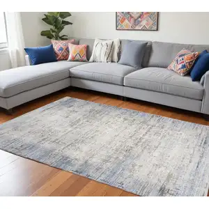 Photo of Blue Gray And Ivory Abstract Area Rug With Fringe