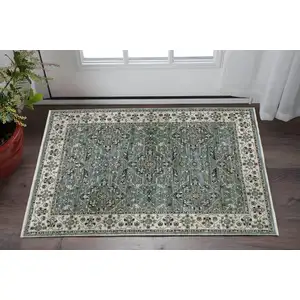 Photo of Blue Green And Beige Floral Area Rug With Fringe