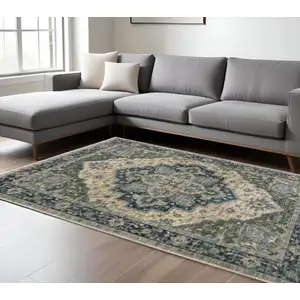 Photo of Blue Grey Beige Tan Green And Gold Oriental Power Loom Stain Resistant Area Rug With Fringe