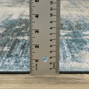 Photo of Blue Grey Ivory Light Blue And Dark Blue Abstract Power Loom Stain Resistant Runner Rug With Fringe