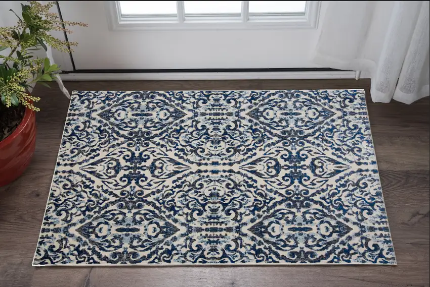 Blue Ivory And Black Floral Distressed Stain Resistant Area Rug Photo 1