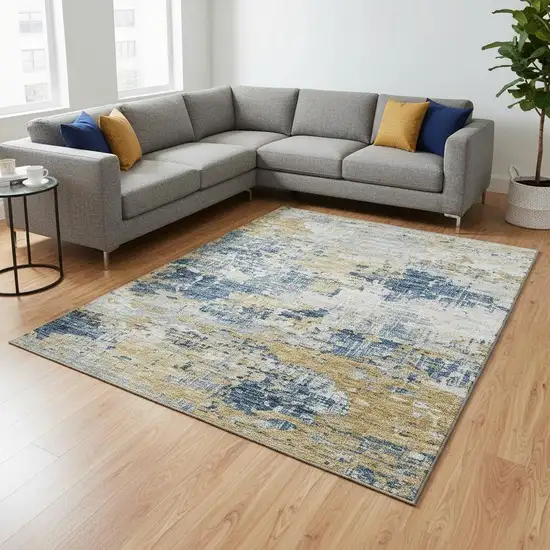 Blue Ivory And Gold Abstract Washable Area Rug With UV Protection Photo 1