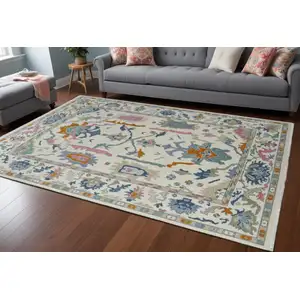 Photo of Blue Ivory and Pink Wool Floral Hand Knotted Area Rug With Fringe