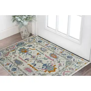 Photo of Blue Ivory and Pink Wool Floral Hand Knotted Area Rug With Fringe