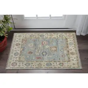 Photo of Blue Ivory and Yellow Wool Floral Hand Knotted Area Rug With Fringe