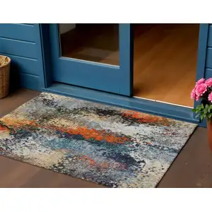 Photo of Blue Orange And Ivory Abstract Washable Indoor Outdoor Area Rug