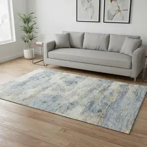 Photo of Blue Silver And Gold Abstract Washable Area Rug With UV Protection
