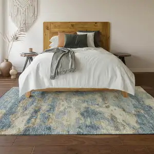 Photo of Blue Silver And Gold Abstract Washable Area Rug With UV Protection