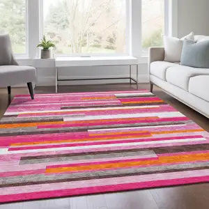 Photo of Blush Orange And Gray Striped Washable Area Rug With UV Protection