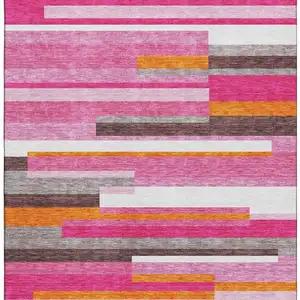 Photo of Blush Orange And Gray Striped Washable Area Rug With UV Protection