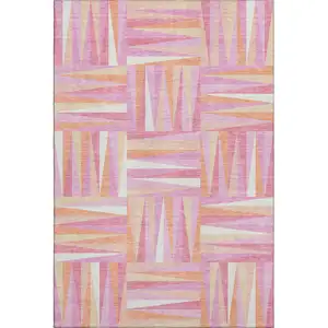 Photo of Blush Peach And Ivory Geometric Washable Area Rug With UV Protection