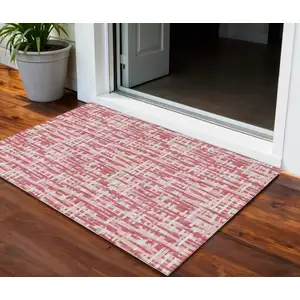 Photo of Blush Pink And Beige Abstract Washable Indoor Outdoor Area Rug