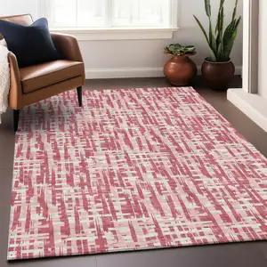 Photo of Blush Pink And Beige Abstract Washable Indoor Outdoor Area Rug