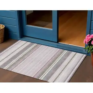 Photo of Blush Purple And Ivory Striped Washable Indoor Outdoor Area Rug