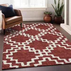 Photo of Brick Red And Ivory Abstract Geometric Washable Area Rug With UV Protection