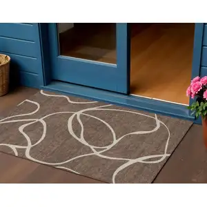 Photo of Brown And Beige Abstract Washable Indoor Outdoor Area Rug