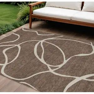 Photo of Brown And Beige Abstract Washable Indoor Outdoor Area Rug