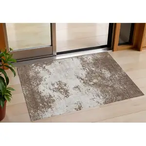 Photo of Brown And Beige Abstract Washable Indoor Outdoor Area Rug