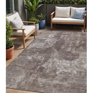Photo of Brown And Ivory Abstract Washable Indoor Outdoor Area Rug
