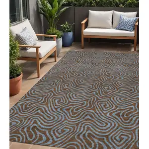 Photo of Brown And Light Blue Abstract Washable Indoor Outdoor Area Rug