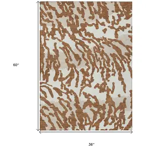 Photo of Brown Beige And Ivory Animal Print Washable Indoor Outdoor Area Rug