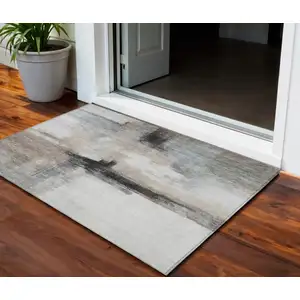 Photo of Brown Black And Gray Abstract Washable Indoor Outdoor Area Rug
