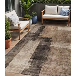 Photo of Brown Black And Tan Abstract Washable Indoor Outdoor Area Rug