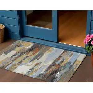 Photo of Brown Blue Ivory And Gold Abstract Washable Indoor Outdoor Area Rug