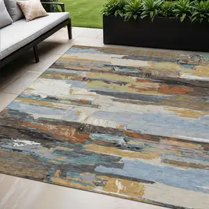 Photo of Brown Blue Ivory And Gold Abstract Washable Indoor Outdoor Area Rug