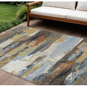Photo of Brown Blue Ivory And Gold Abstract Washable Indoor Outdoor Area Rug