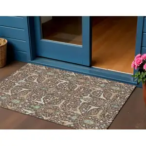 Photo of Brown Green And Ivory Floral Washable Indoor Outdoor Area Rug