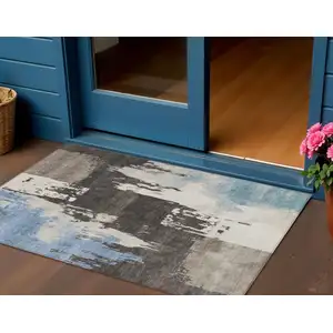 Photo of Brown Ivory And Blue Abstract Washable Indoor Outdoor Area Rug