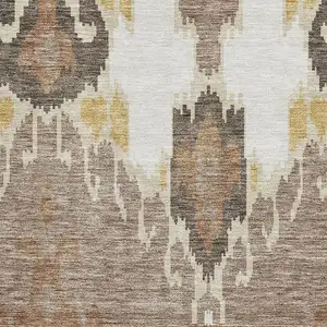 Photo of Brown Ivory And Gold Ikat Washable Area Rug With UV Protection