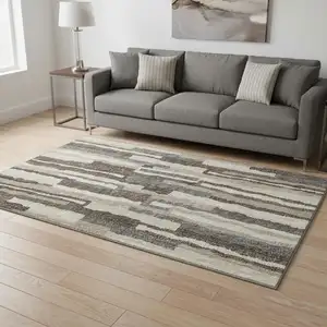 Photo of Brown Ivory And Gray Abstract Washable Area Rug With UV Protection