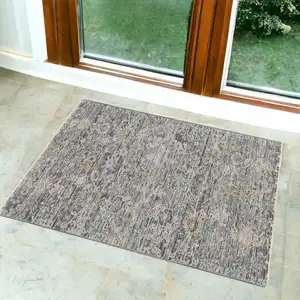 Photo of Charcoal Brown And Ivory Floral Distressed Area Rug With Fringe