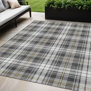 Photo of Charcoal Ivory And Gold Plaid Washable Indoor Outdoor Area Rug