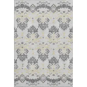 Photo of Charcoal Silver And Gold Medallion Washable Area Rug With UV Protection