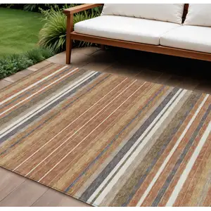 Photo of Chili Red Ivory And Gold Striped Washable Indoor Outdoor Area Rug