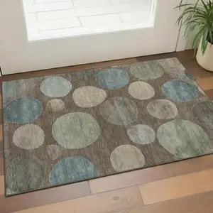 Photo of Chocolate And Teal Geometric Washable Area Rug With UV Protection