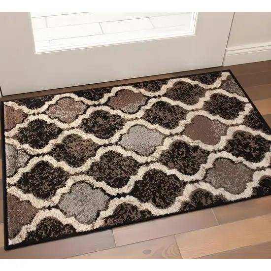 Brown Black And Ivory Quatrefoil Distressed Area Rug Photo 1