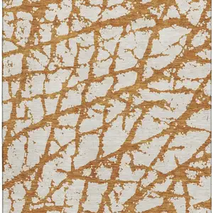 Photo of Copper And Ivory Abstract Washable Area Rug With UV Protection