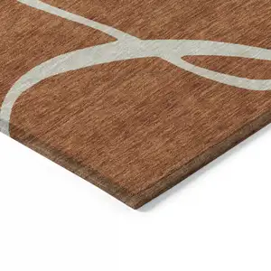 Photo of Copper And Ivory Abstract Washable Indoor Outdoor Area Rug
