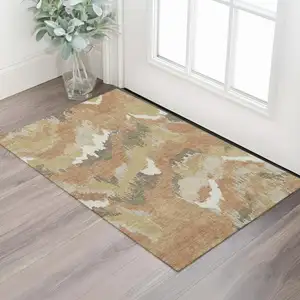 Photo of Copper Gold And Ivory Abstract Washable Area Rug With UV Protection